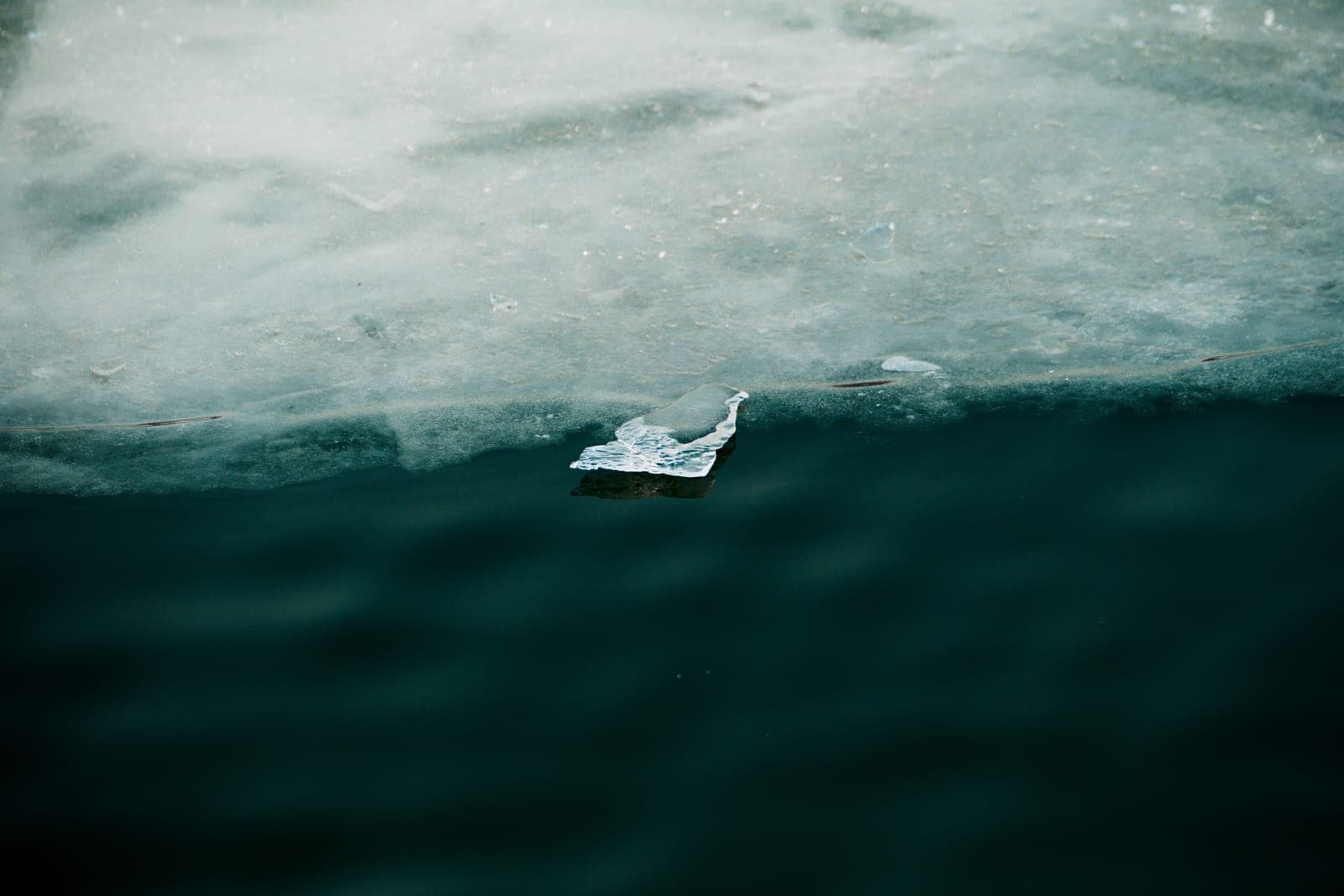 Edge of a sheet of ice meeting dark open water